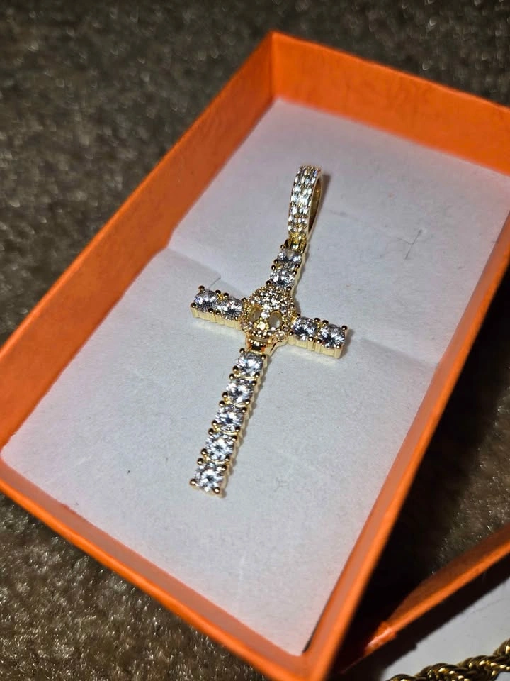 Gold chain with a cross-shaped pendant and a skull covered in zi - photo 4