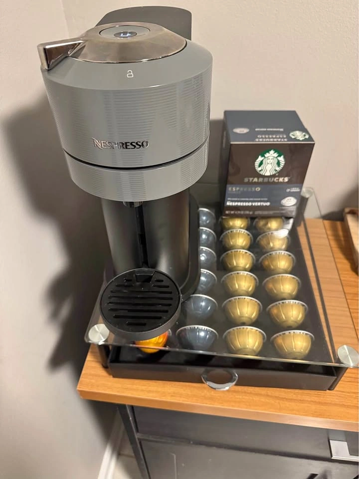 Nespresso coffee machine with glass pod holder and pods