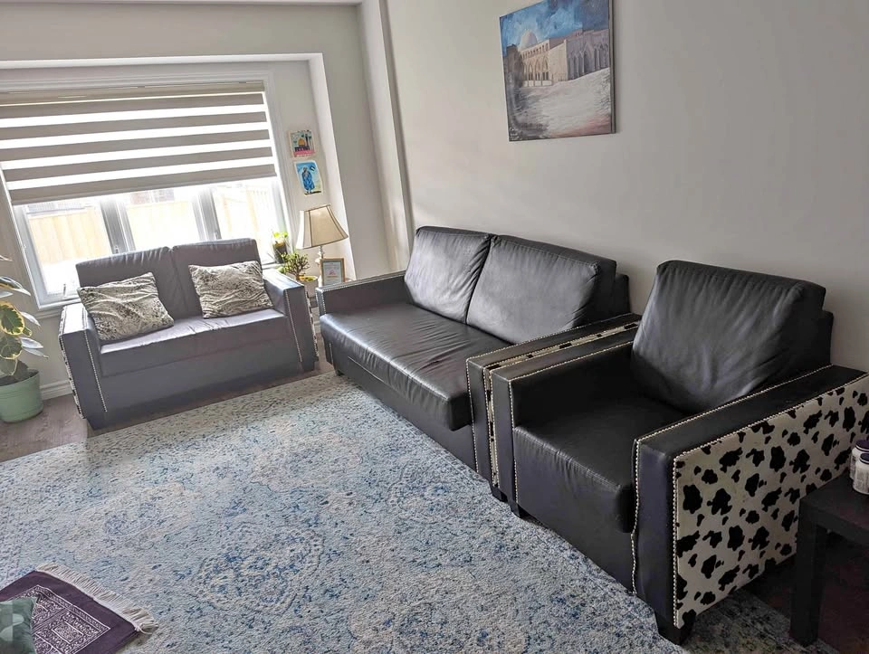 Black faux leather couch and armchair set with cow print