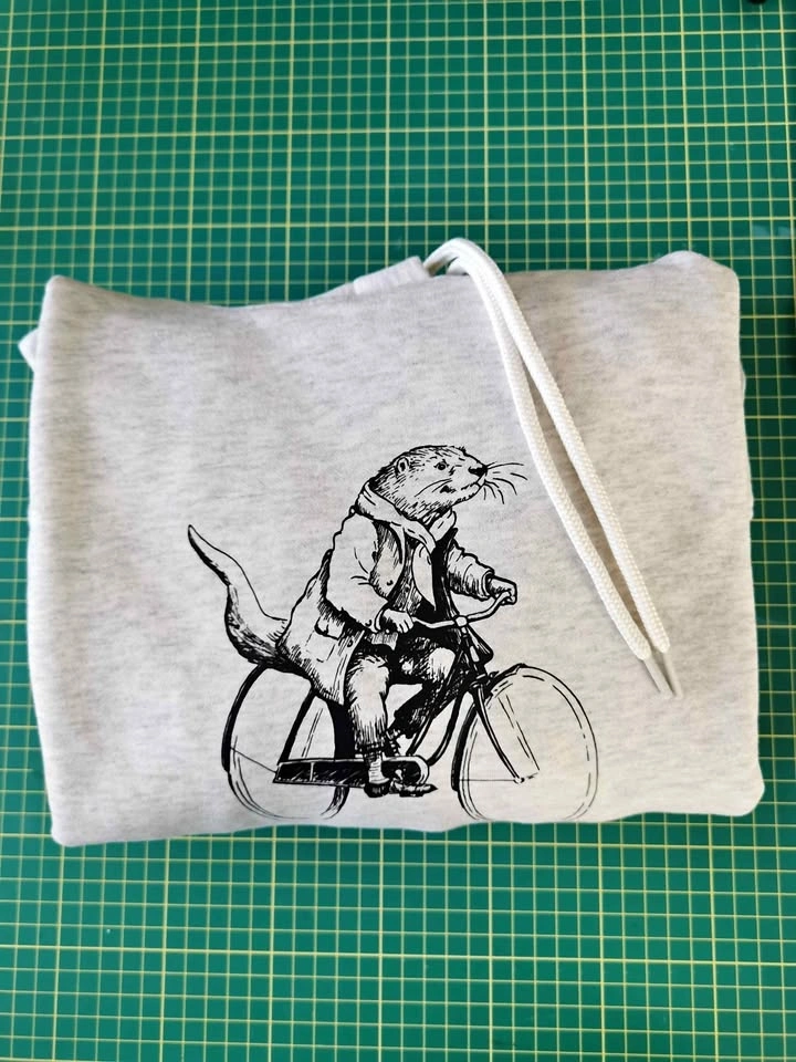 Otter on bicycle hoodie - SM left