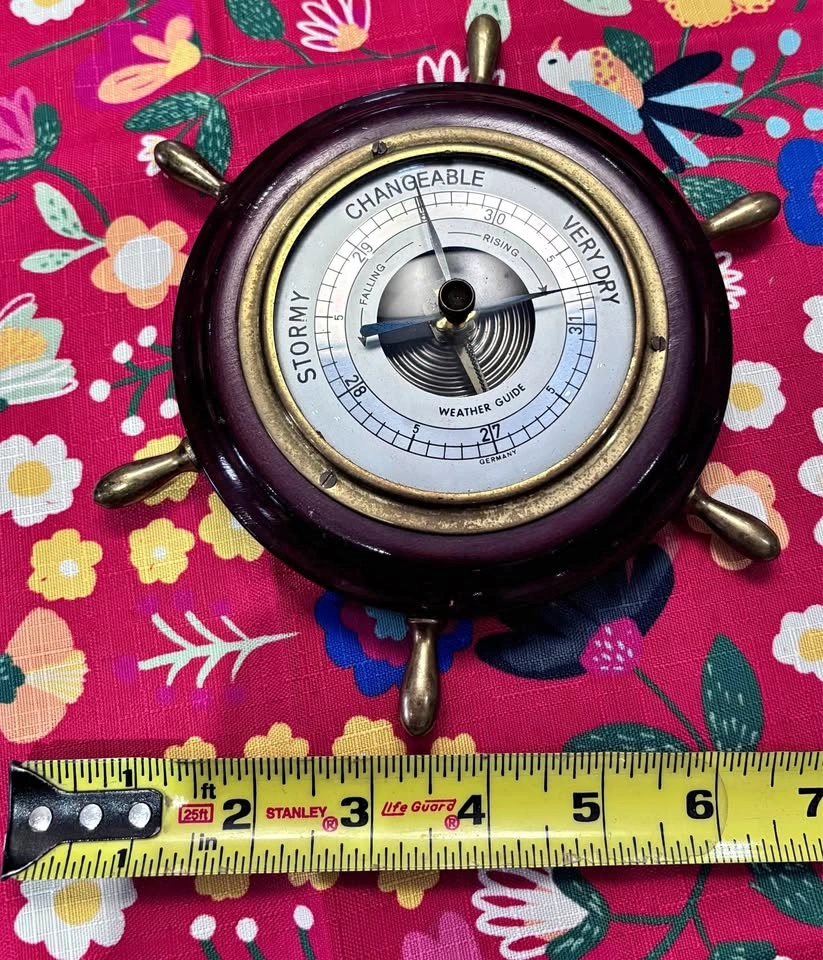 Vintage Weather Guide is a ship's wheel barometer