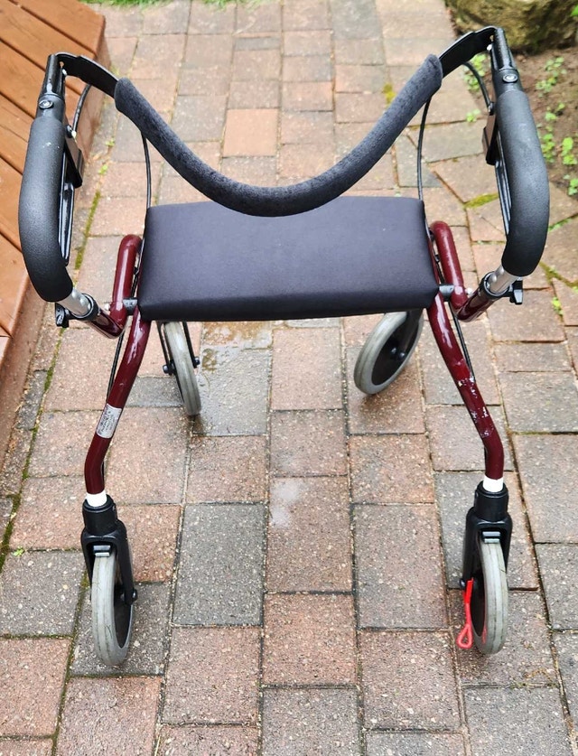 Walker w/ seat and brakes. Fully adjustable.