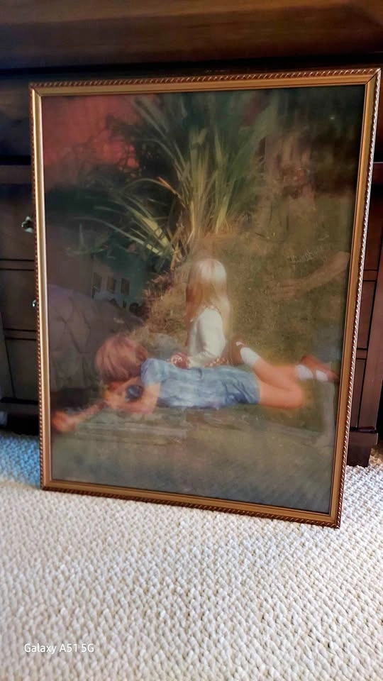 Little girl and boy by pond