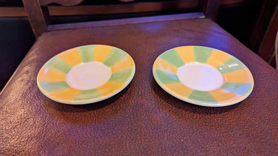 Pair of green and yellow tea cup saucers