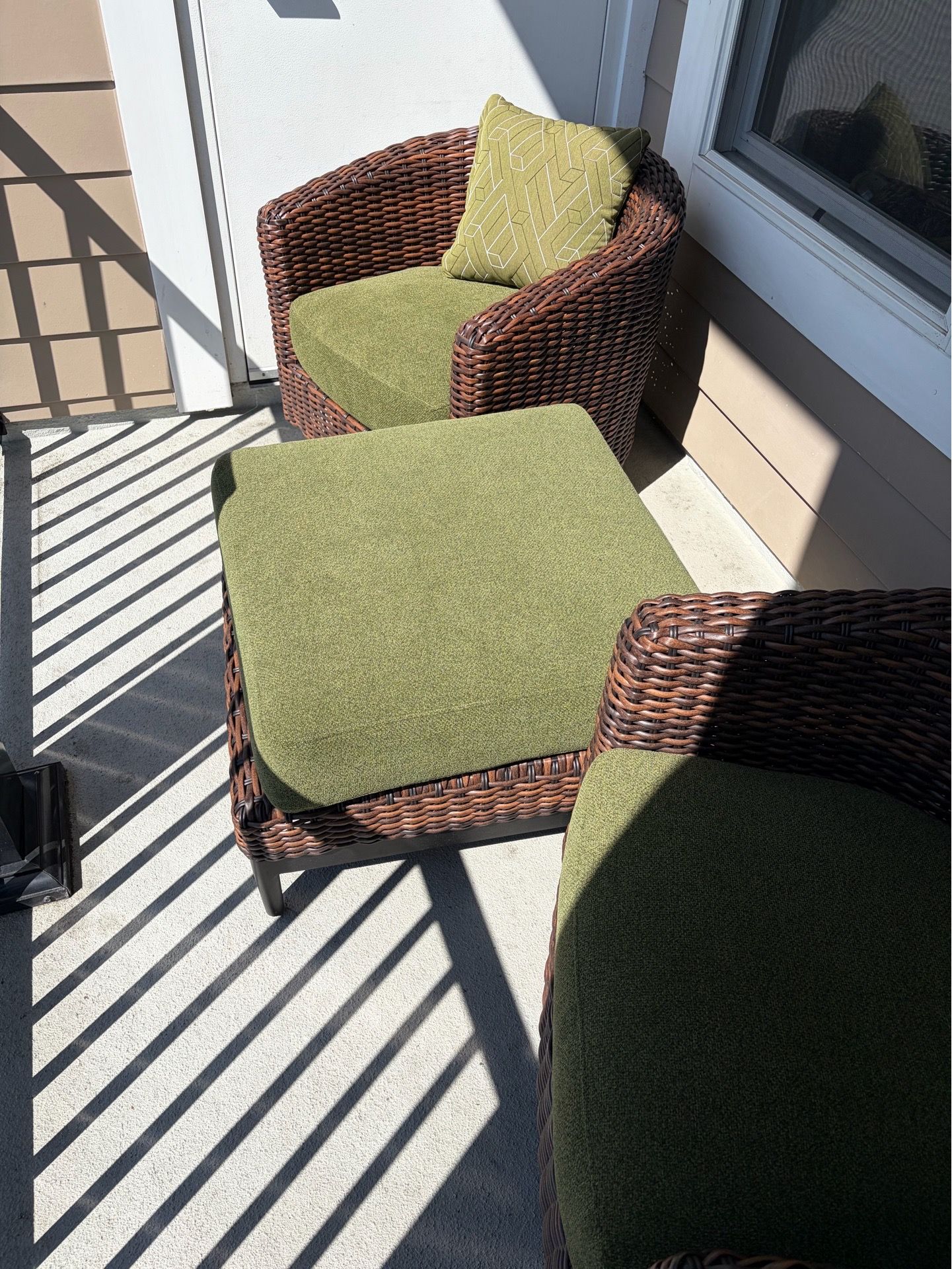 Outdoor wicker swivel chairs and ottoman