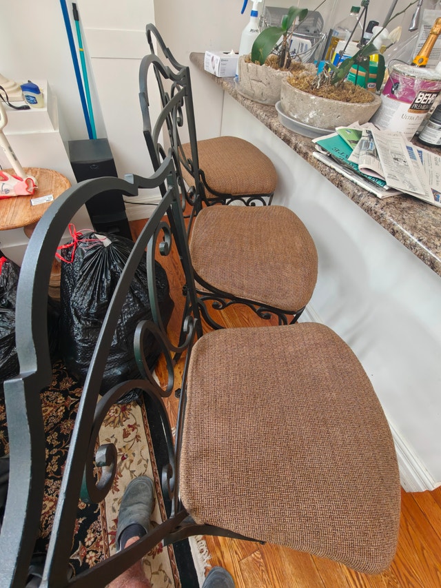 Three breakfast barstools. Wrought iron, reappolstured seating.