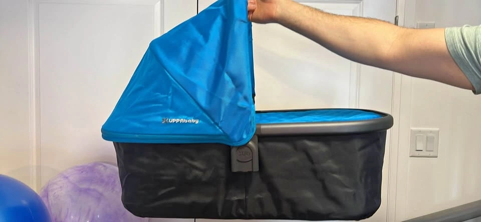 Uppababy blue bassinet with cover