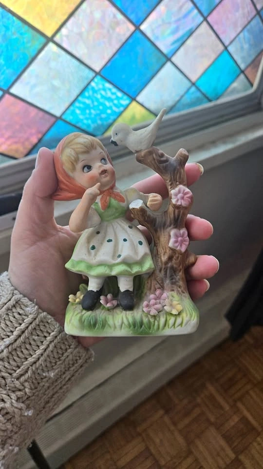 girl and bird figurine