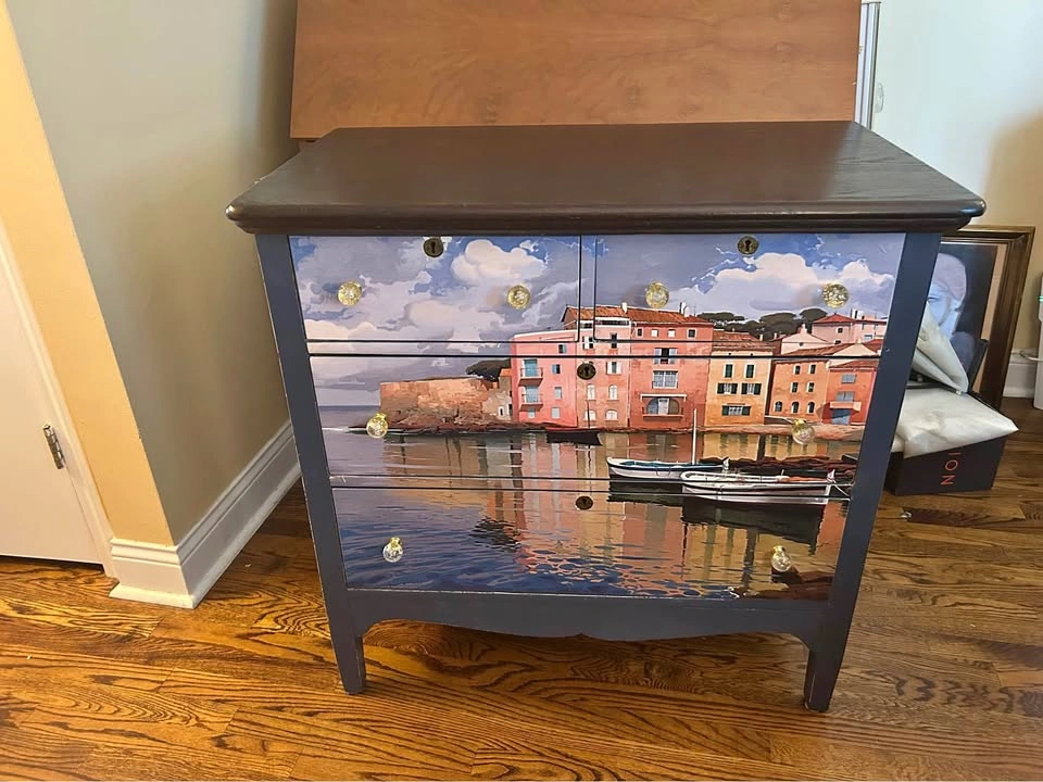 Painted and papered dresser with scenic picture