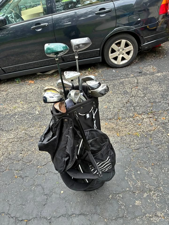 Adidas golf bag with various clubs