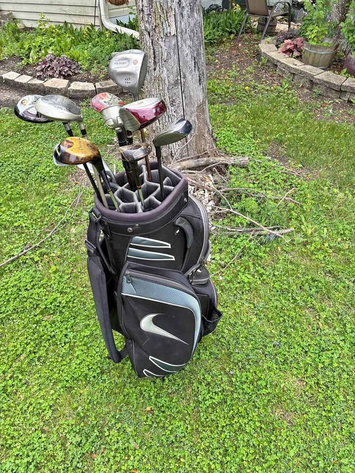 Nike golf bag with various golf clubs