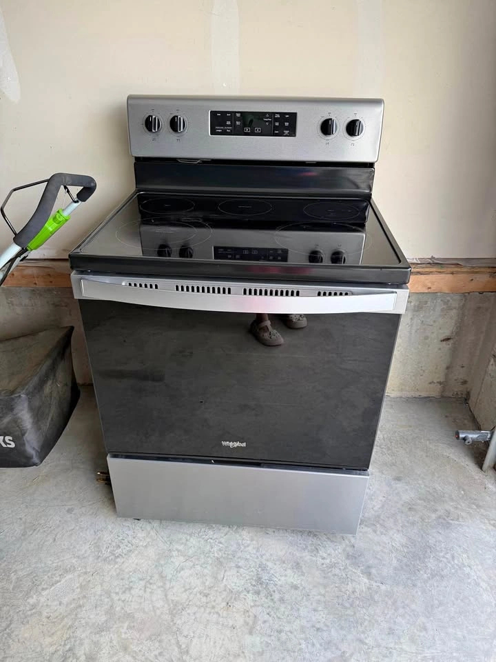 Whirlpool stainless steel and black electric range
