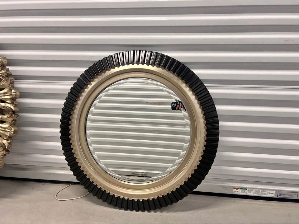 Mirror with gold and black ribbed frame