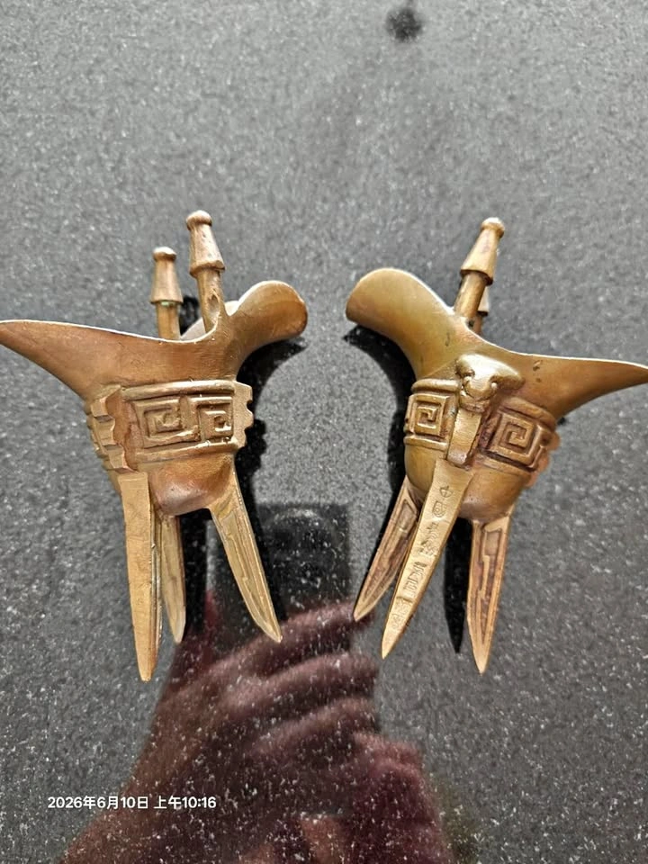 Pair of Chinese bronze wine vessel replicas (Jue)