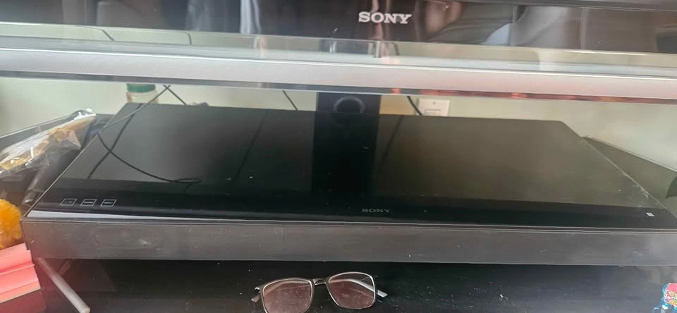 Sony TV and black glass stand and Sony speaker - photo 4