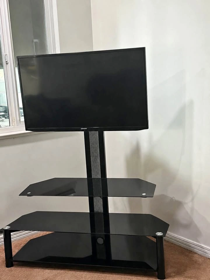 Samsung TV with modern black glass TV stand