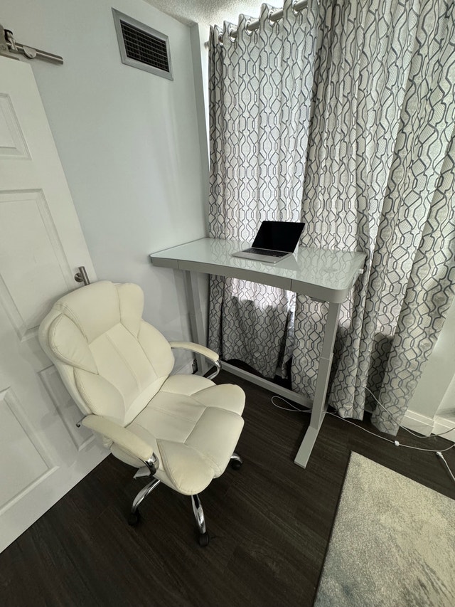 Height-adjustable glass-top desk + revolving chair