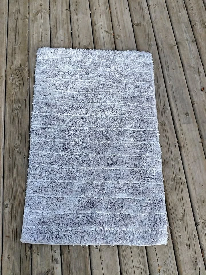 Two white bath mats for sale