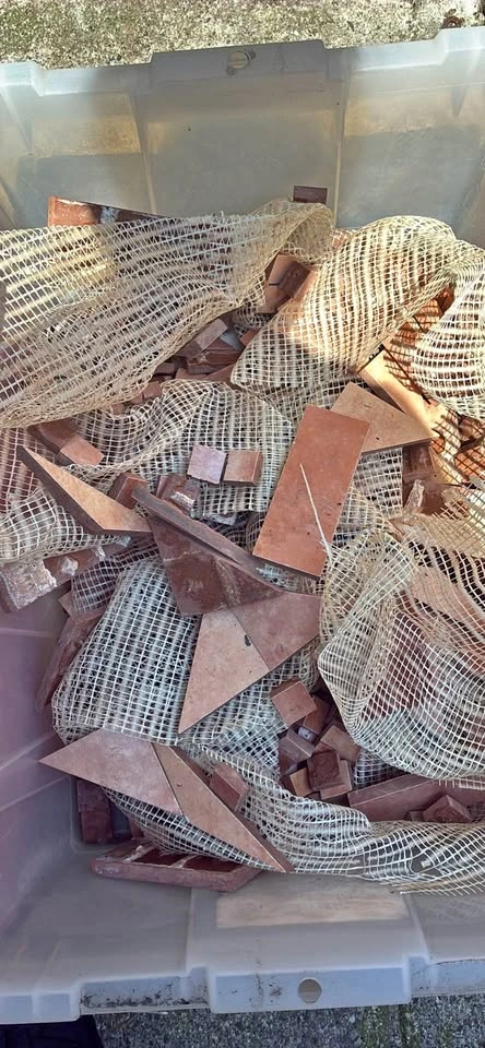 Box of broken tile pieces