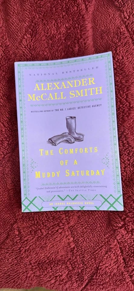 The Comforts of a Muddy Saturday – Alexander McCall Smith