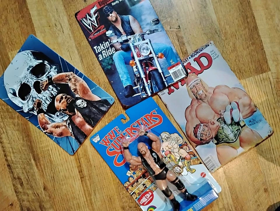 Stone Cold action figure, tin signs, and 90s belts