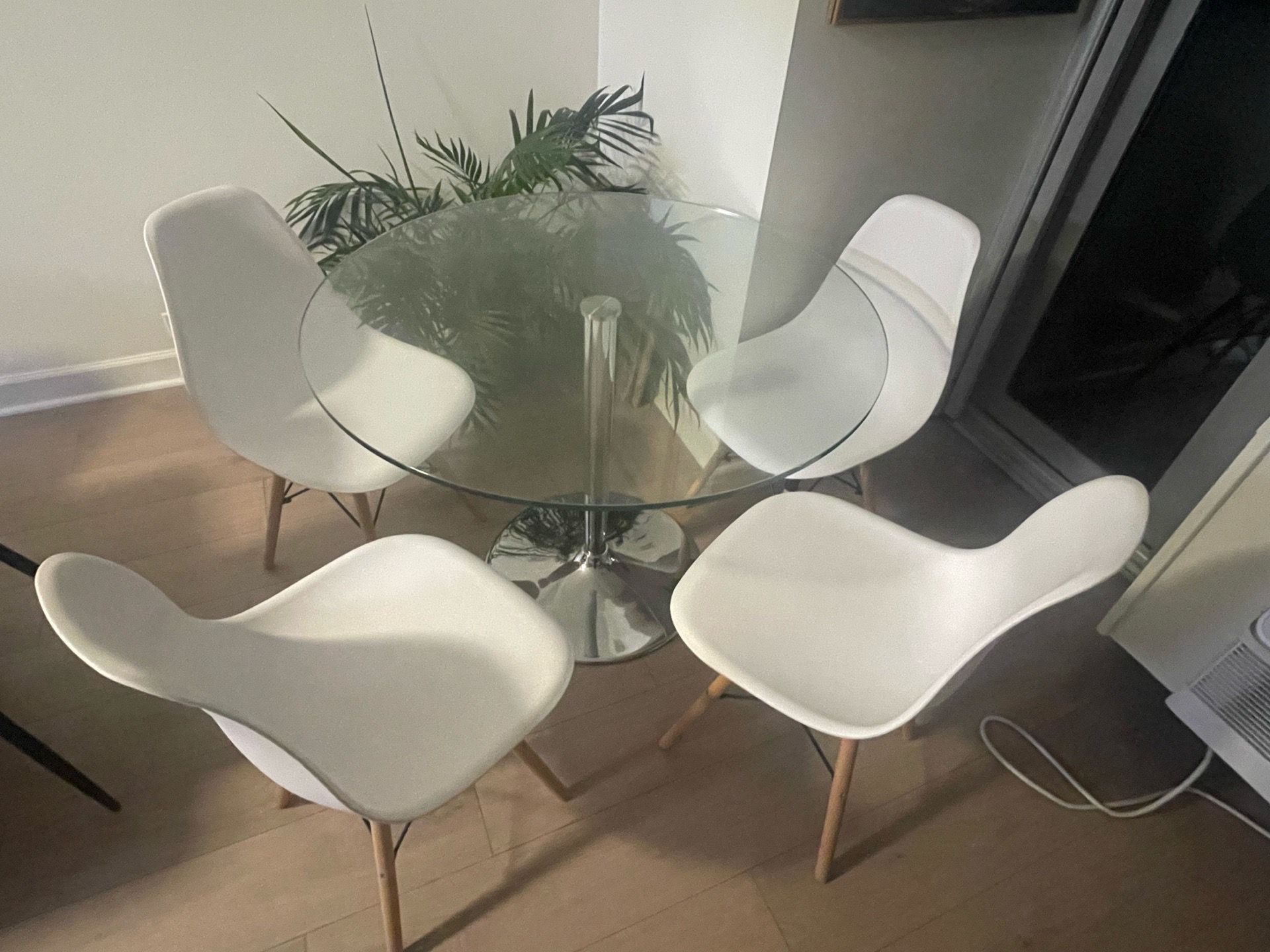 Round glass table and white chairs