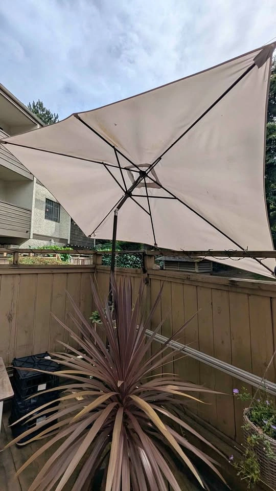 Large rectangular, tilting outdoor umbrella with base