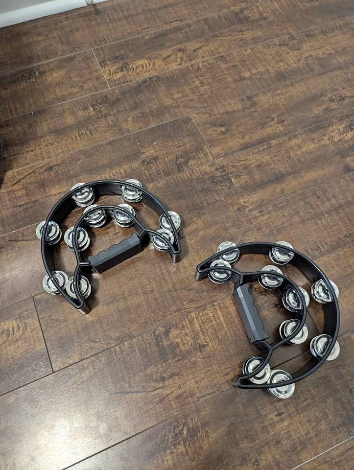 Two black coloured tambourines