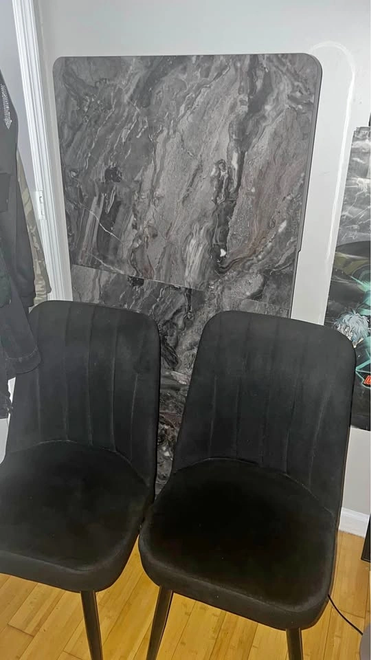 Extended solid wood dining table with 4 black chairs