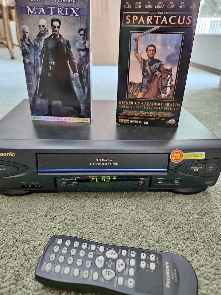 Panasonic 4 HEAD VCR with remote and movies.