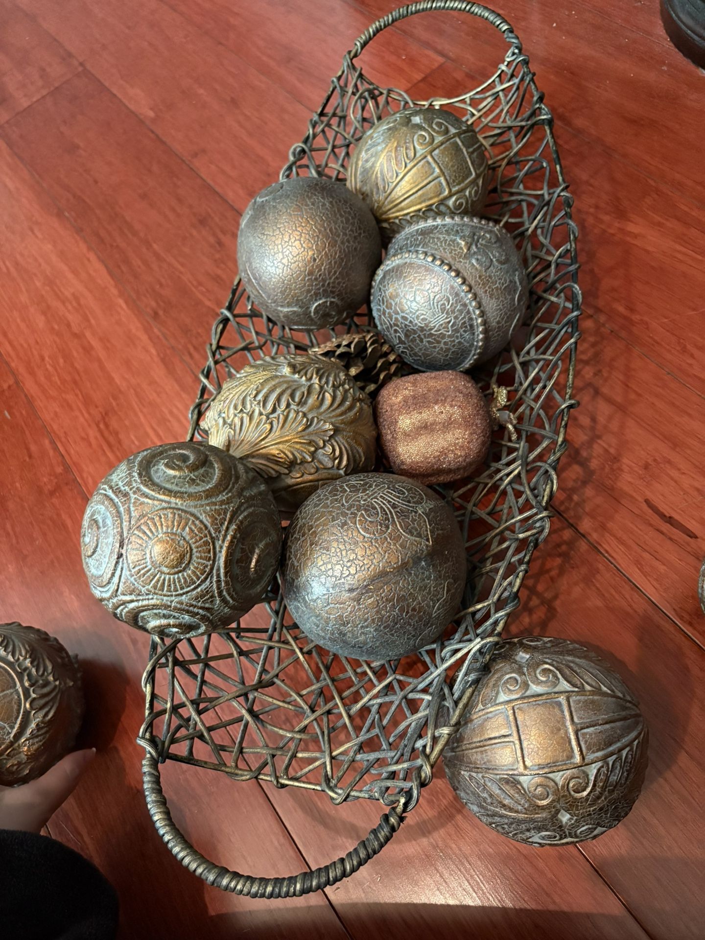 Set of vintage-style decorative balls or orbs in a metal basket