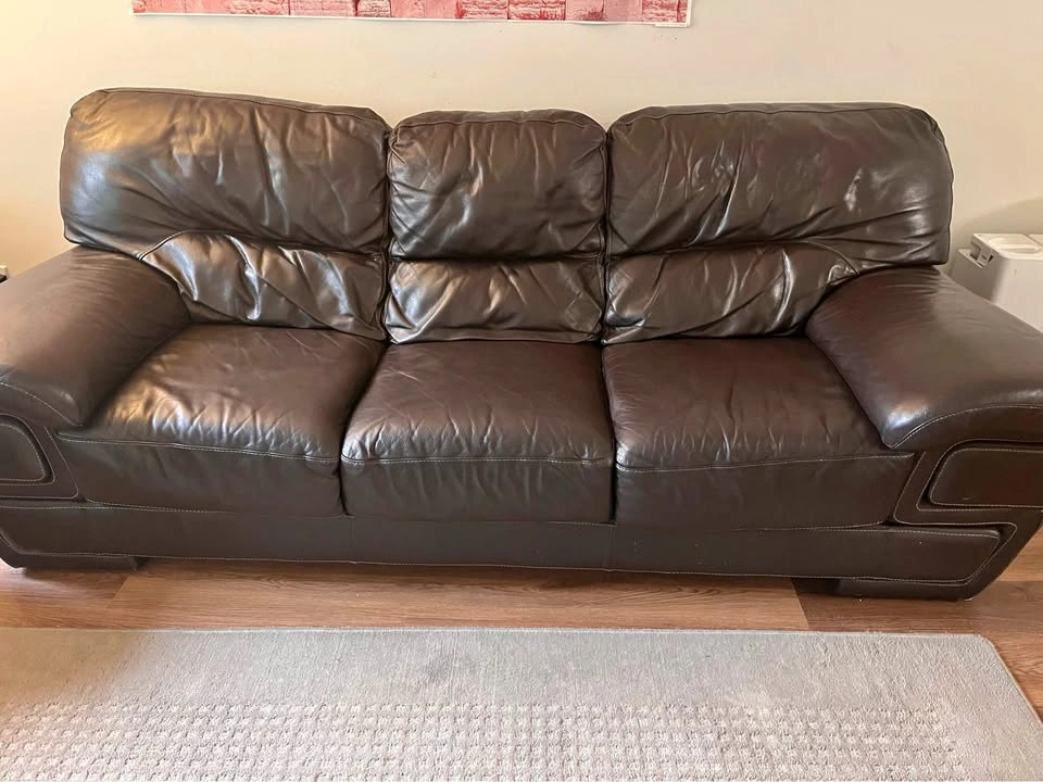 Brown genuine LEATHER couches plus a side table and a coffee tab