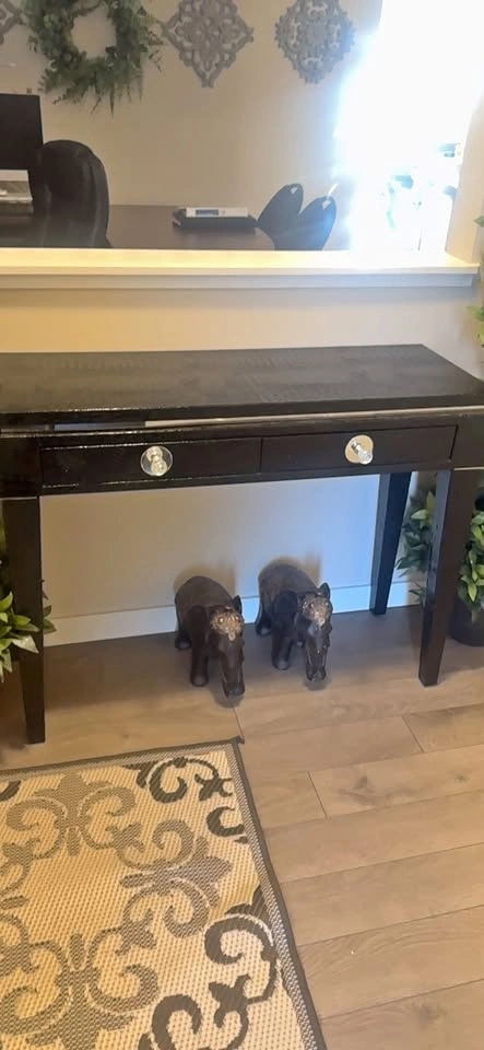 Black Console Table with Drawers and Elephant Figurines