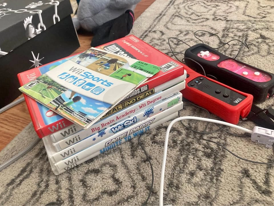 Nintendo Wii with cords, accessories, remotes, and games