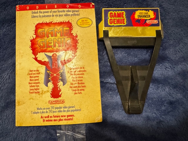 NINTENDO GAME GENIE VIDEO GAME ENHANCER + BOOK
