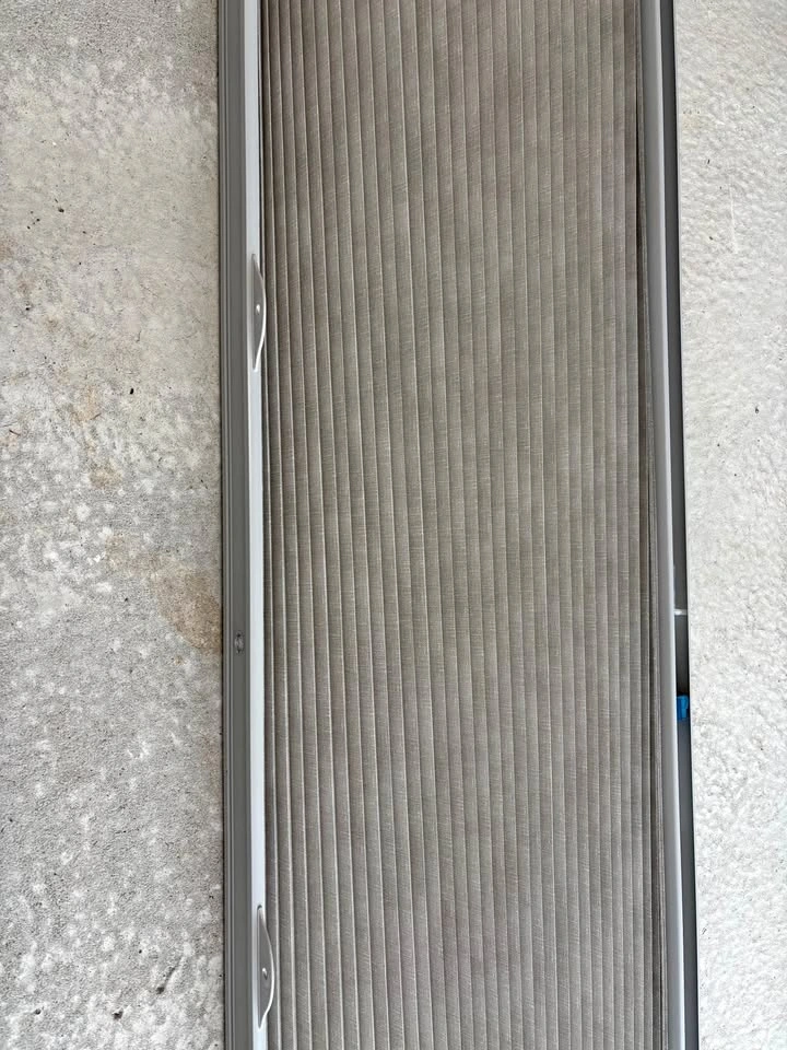 Beige fabric accordion blinds