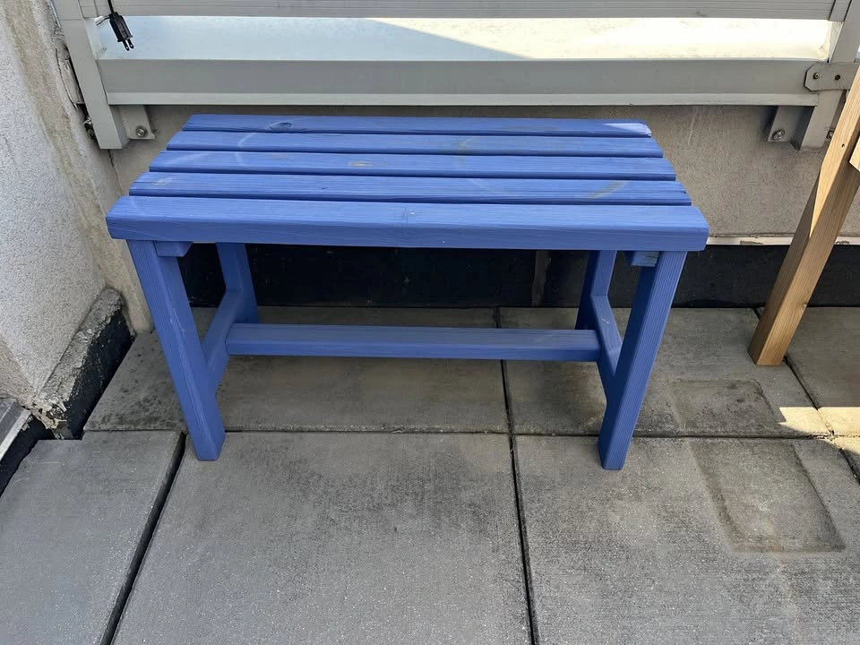 Small blue wooden outdoor bench