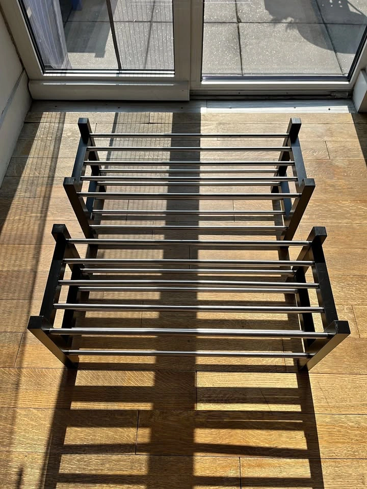 Two IKEA TJUSIG shoe racks