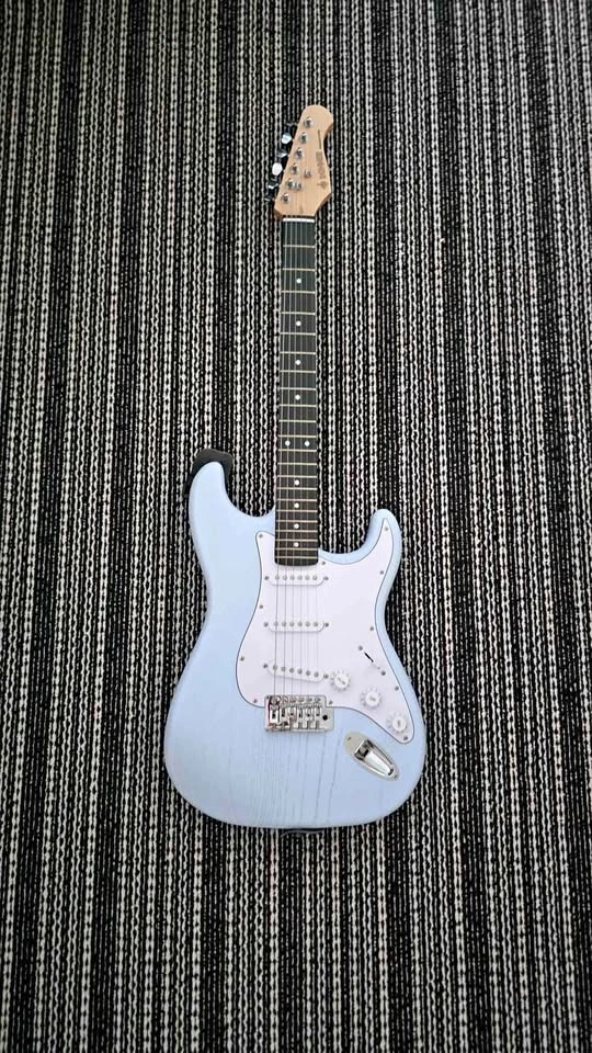 Donner blue electric guitar with strap