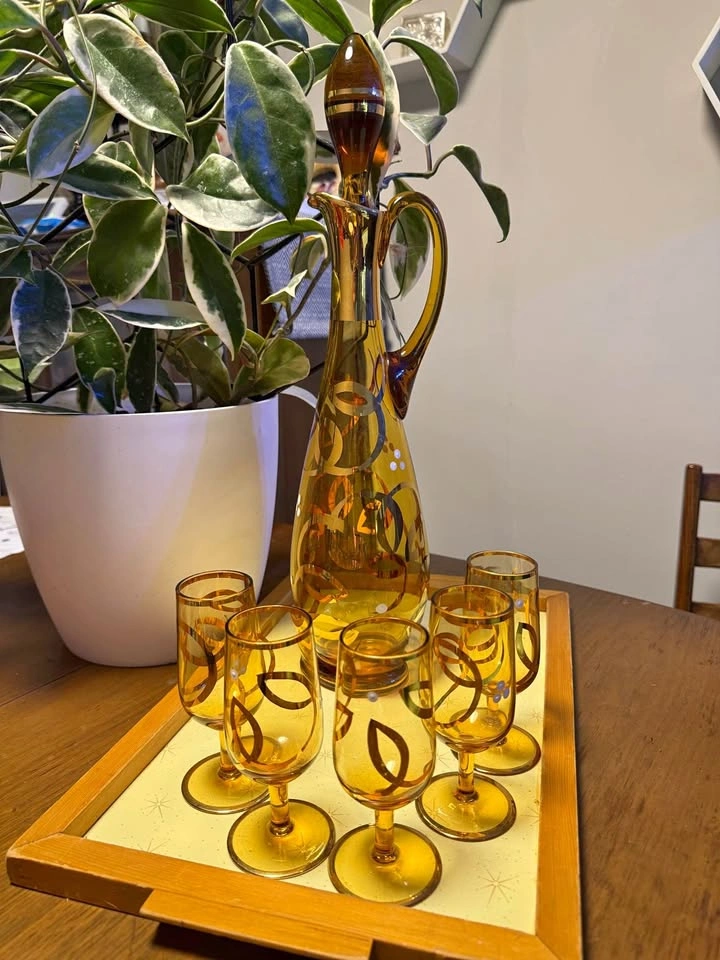 Vintage amber glass decanter and cordial set with gold overlay
