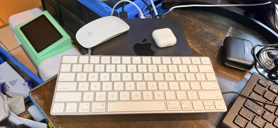 Apple Mac mini with Apple Keyboard, Magic Mouse, and AirPods