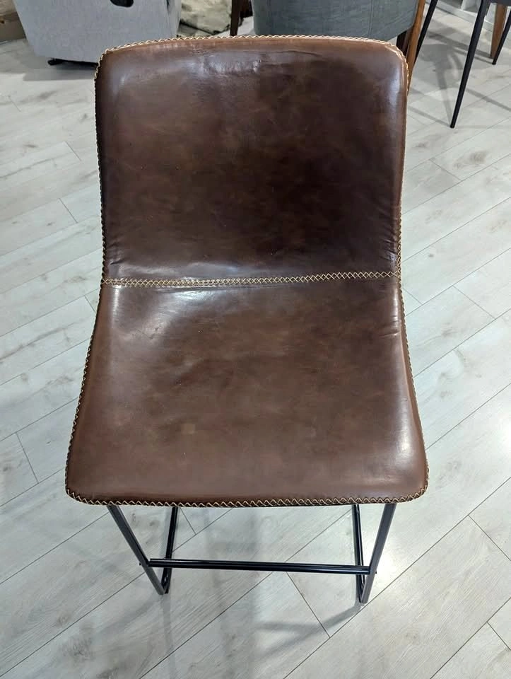 2 brown leather barstools with black legs