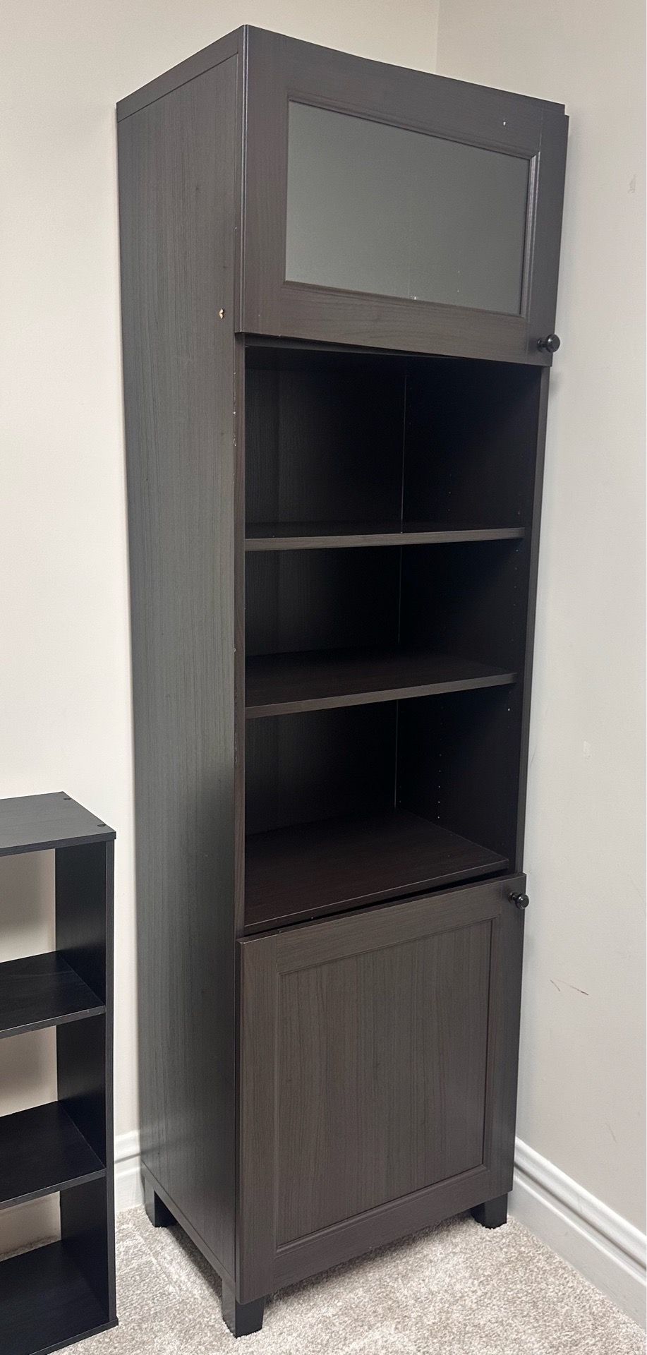 Tall IKEA BESTÅ bookshelf with doors