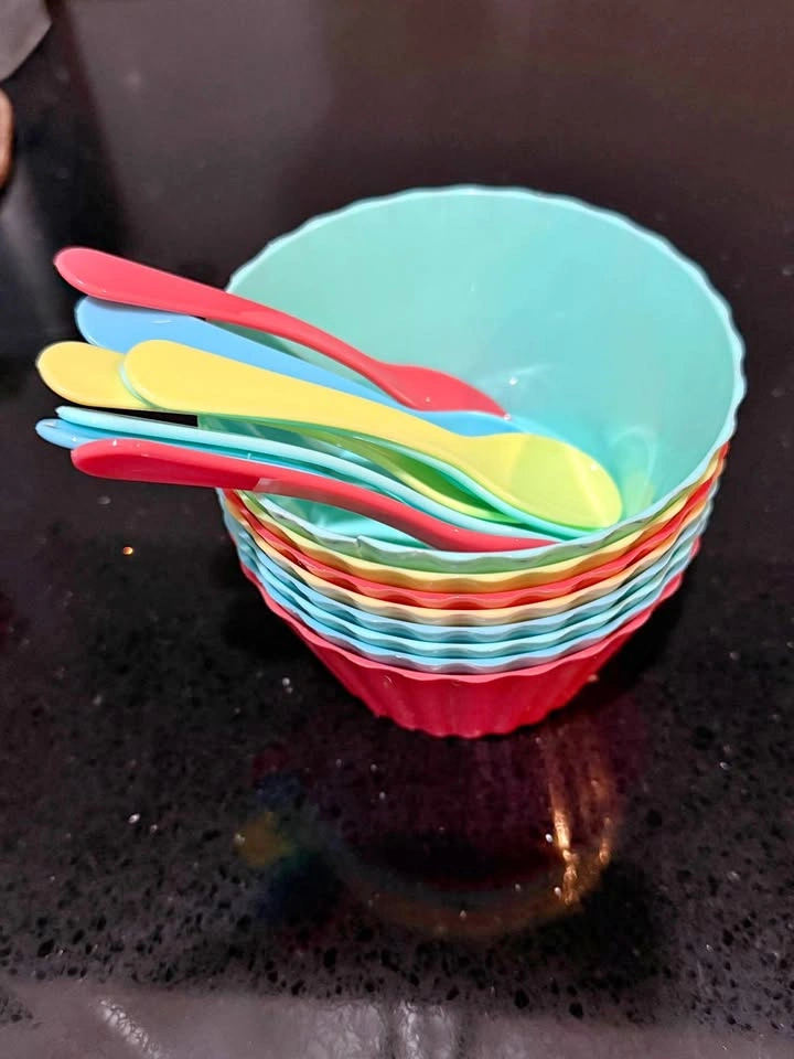 Colorful plastic bowls and spoons set for ice cream