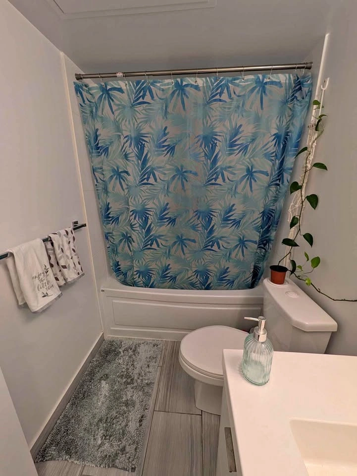 Teal bathroom accessories - bathmat, towel, curtain, soap bottle