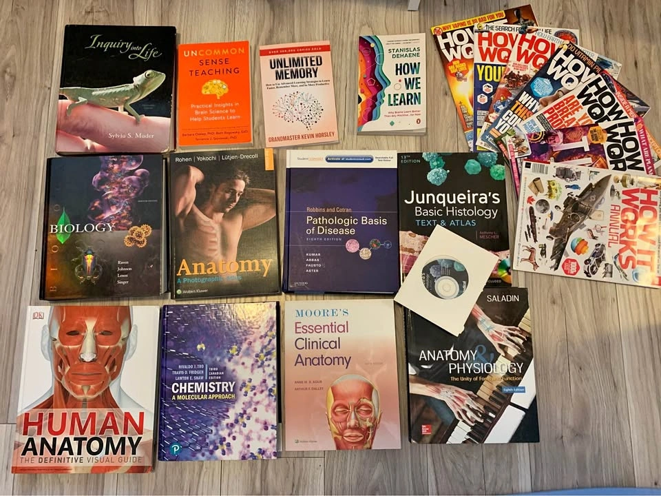 Bundle of textbooks and self help books and magazines