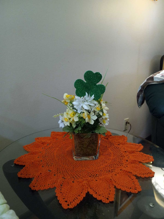 Plastic flower arrangement in glass jar