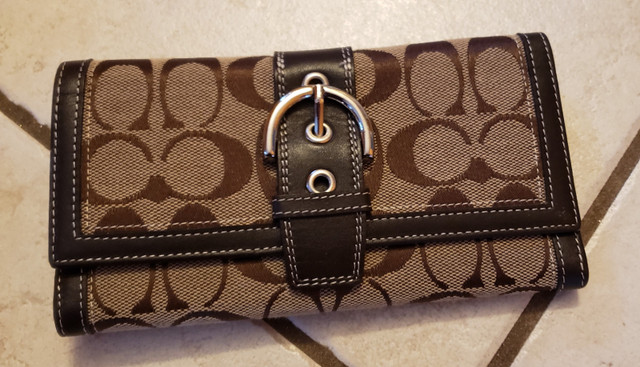 Brown Leather Coach Wallet with buckle and classic coach c logo