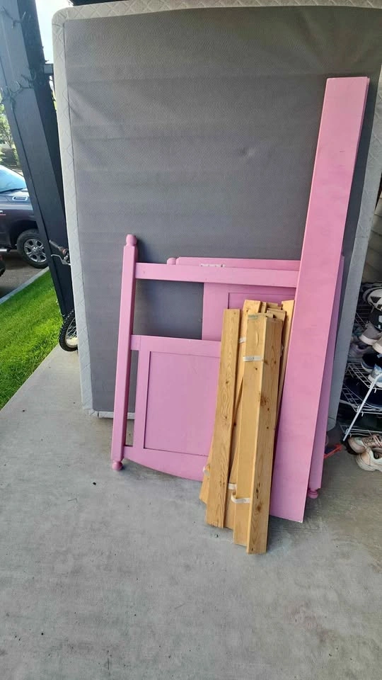 Single bed pink color and a mattress frame