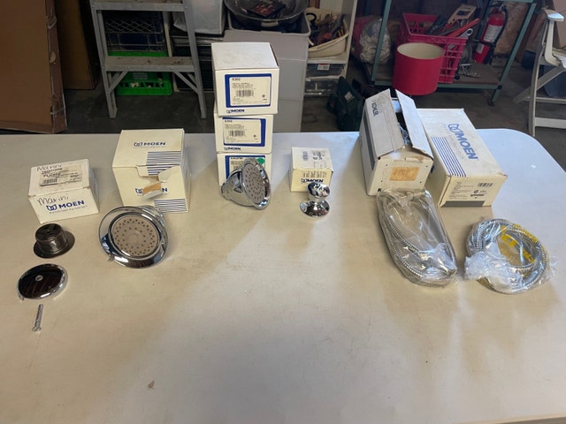 Moen shower heads, shower head hoses and a mini shower head